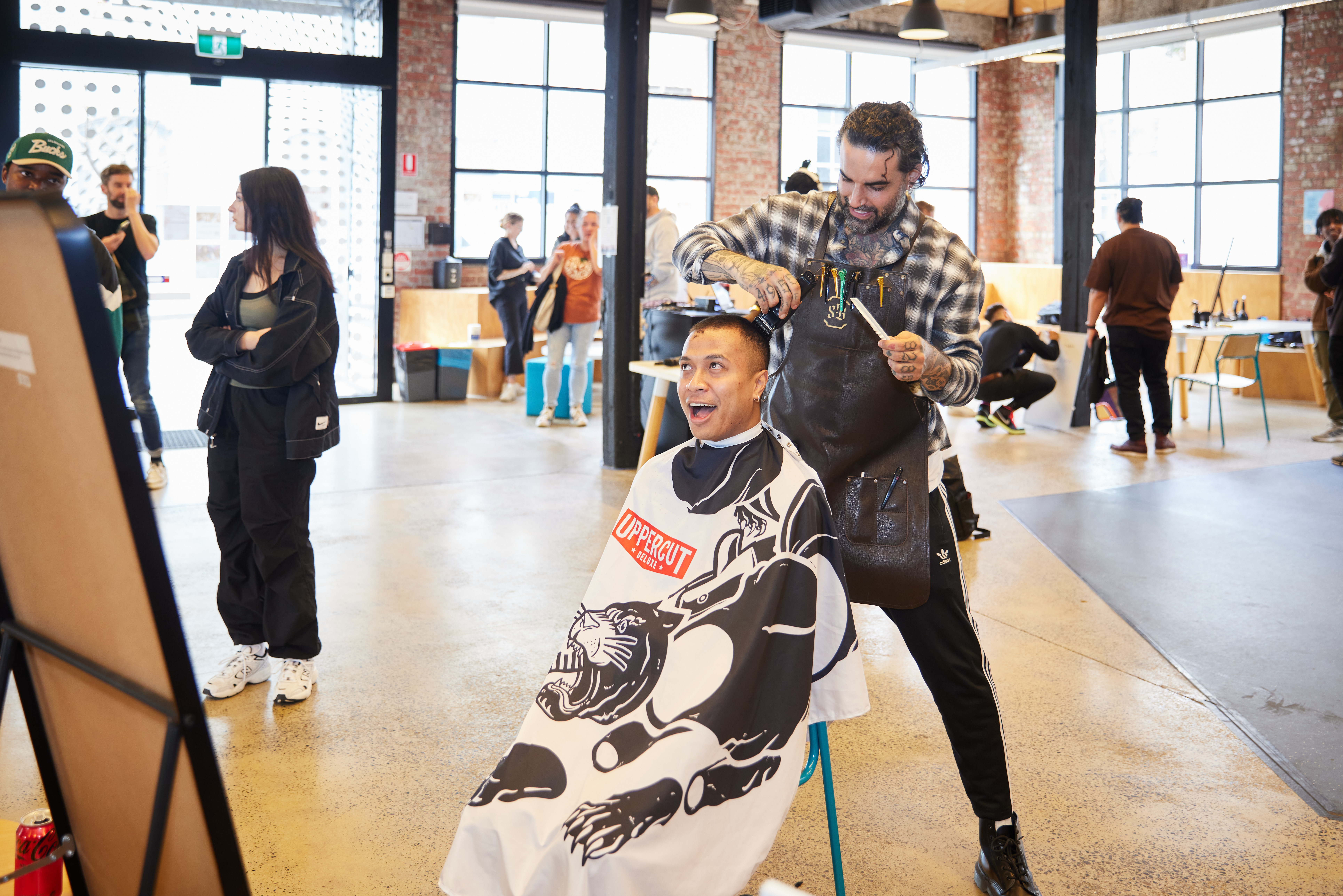 Nasir Sobhani, a barber, cuts a students hair.
