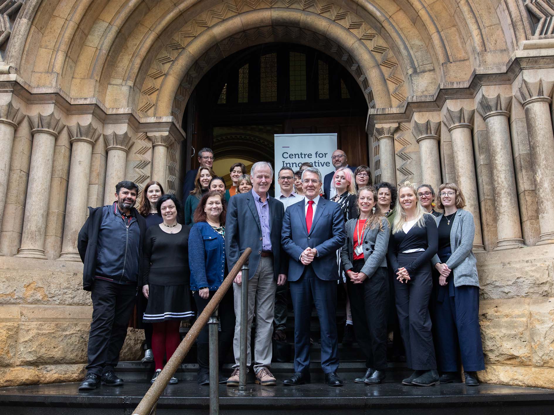 A group of people stand at the entryway to the Old Magistrates' Court