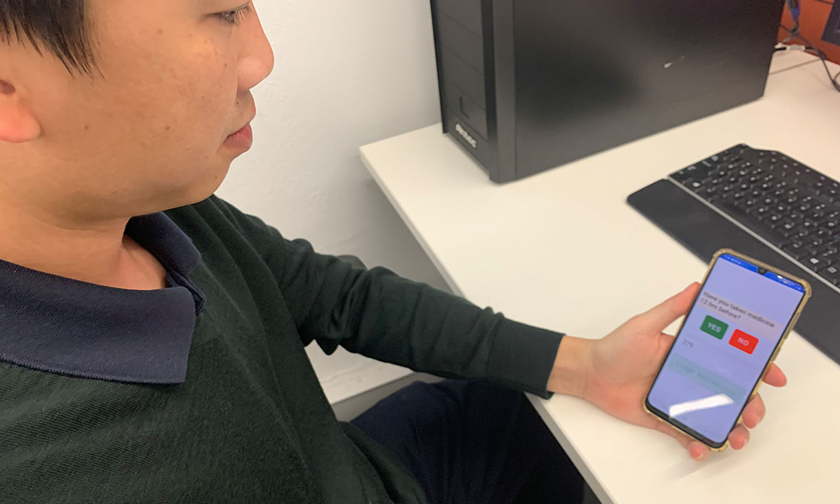 Dr Quoc Cuong Ngo, from RMIT’s School of Engineering, uses the team's voice screening App. Credit: RMIT University