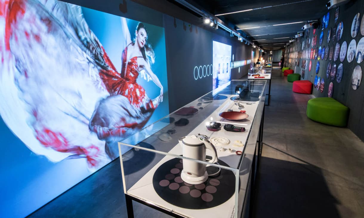 a corridor with a series of designs on display