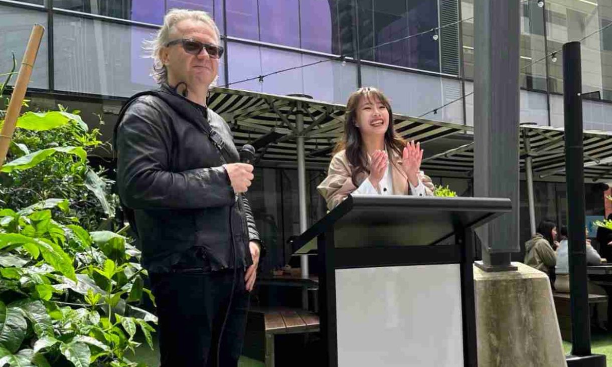 Creator Dyann Fang speaks at podium alongside Dr Jan van Schaik