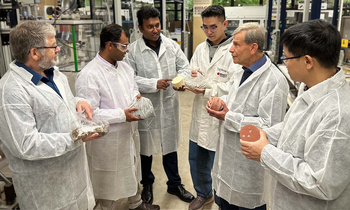 Team leader Associate Professor Dilan Robert (third from left) with the RMIT research team behind the energy-smart bricks in a lab at RMIT University. Credit: Seamus Daniel, RMIT University