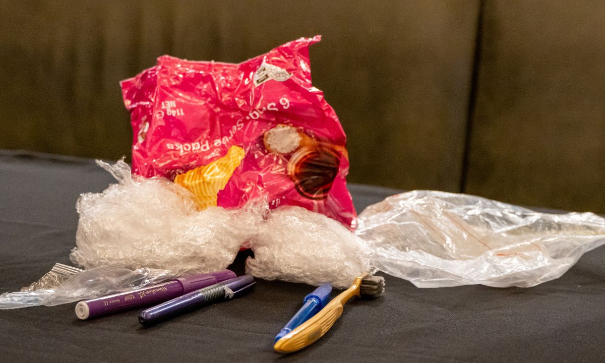 Different types of plastic waste, including discarded chip packet, plastic wrap, pens and a toothbrush