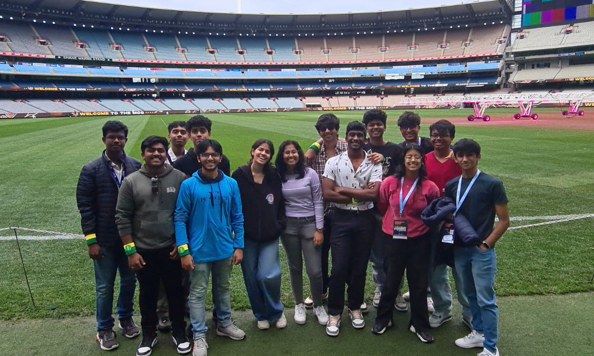 A group of students standing on the ground of the MCG.