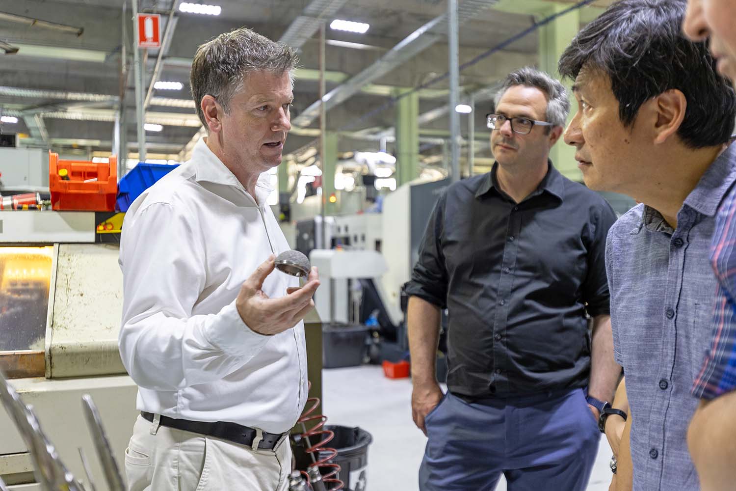 Dr Declan Brazil taking researchers on a tour of the Signature Orthopaedics manufacturing facility.