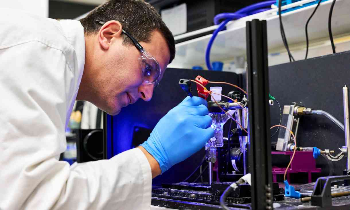 Researcher working on machine