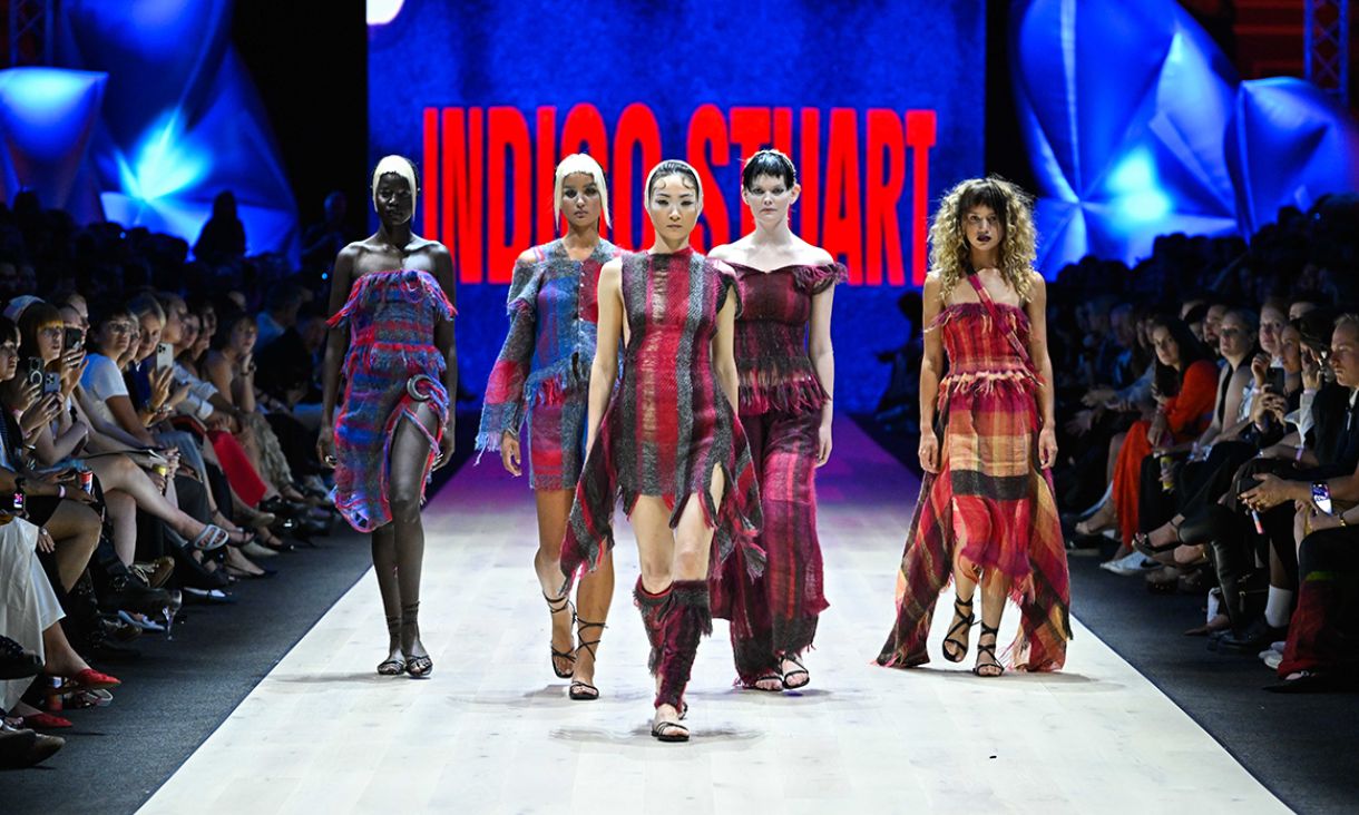 Models on runway wearing various dresses