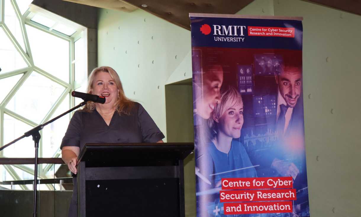 Mish Eastman speaking at lectern.