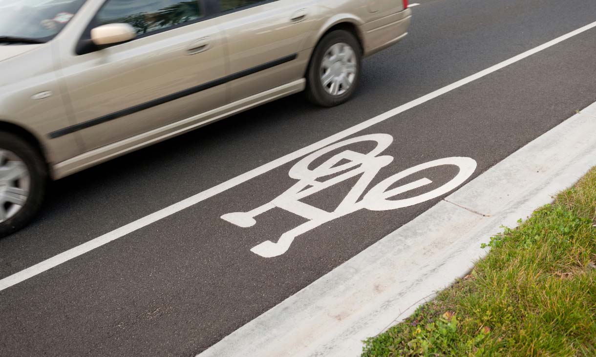 car next to bike lane