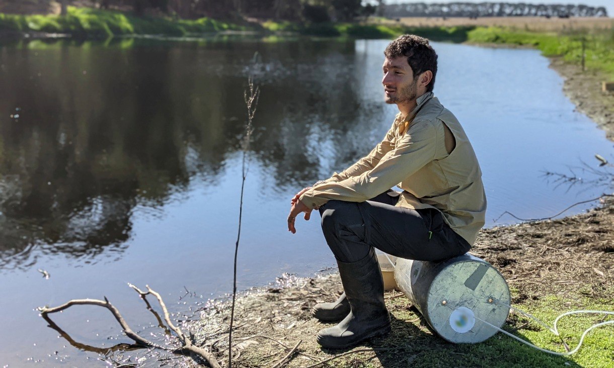 Image of Martino Malerba sitting next to a farm dam.