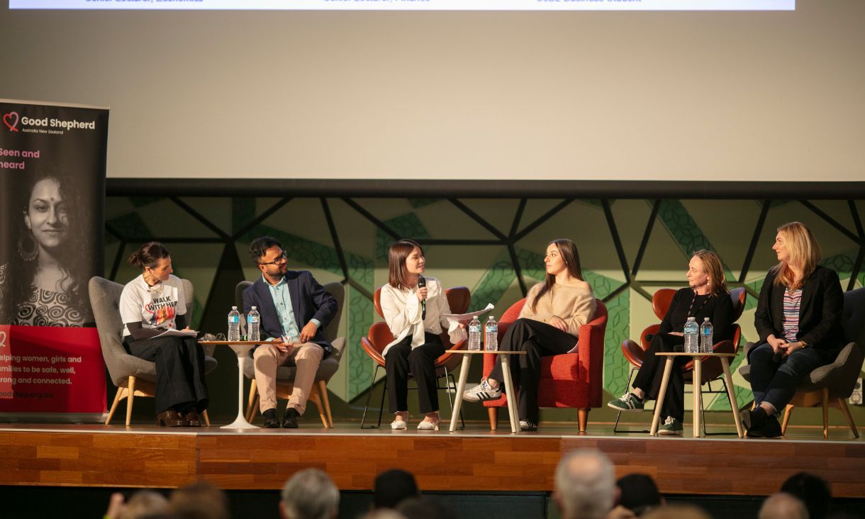 People sitting in chairs taking part in panel discussion