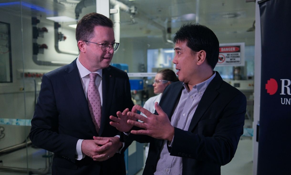 Two men in conversation in a lab.