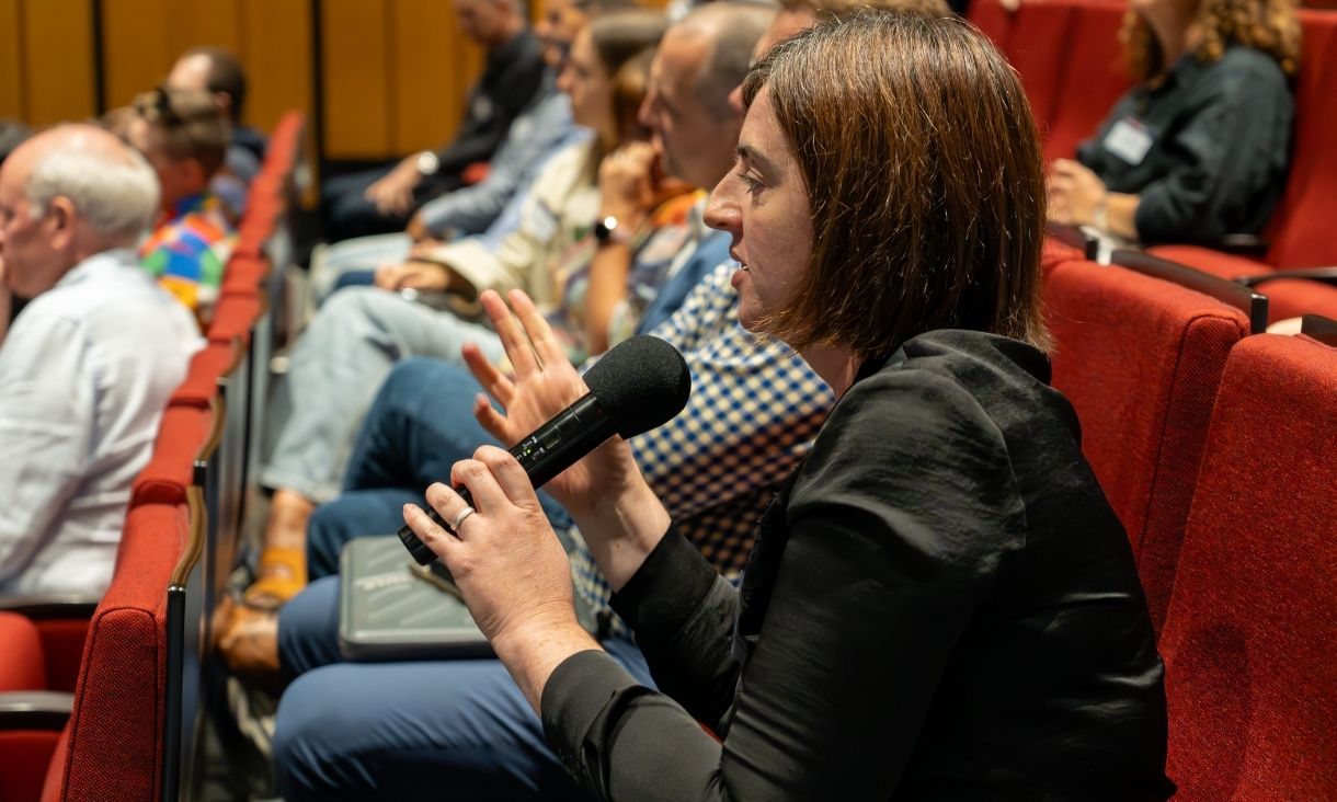 Audience members and panelists were invited to discuss topics further within the symposium. Image: Mairead Foley