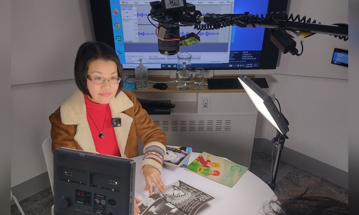 Gabe Clark, Chief Investigator, interviewing manga-style comic book writer and artist Queenie Chan