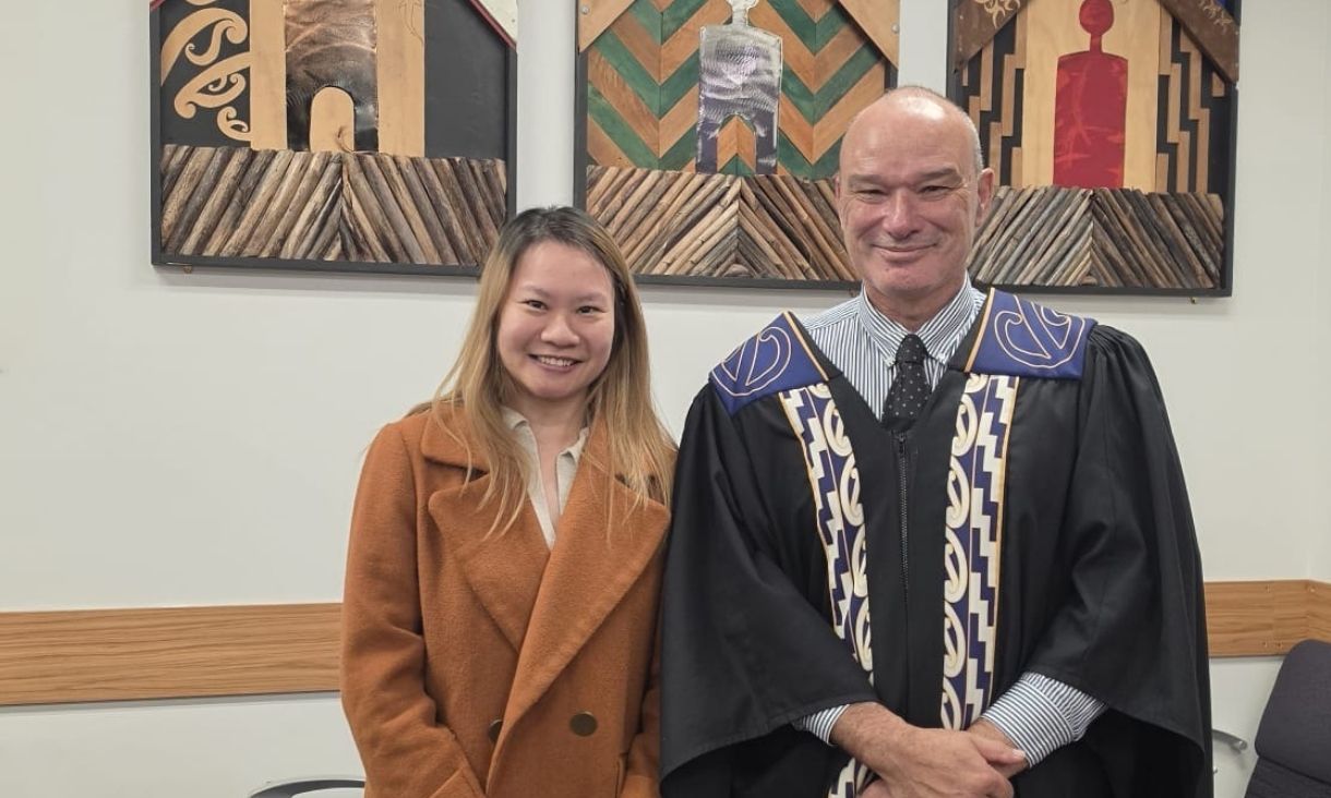 Student posing with judge.
