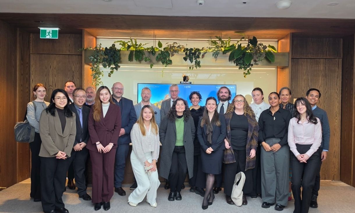 Group of students posing inside legal building.