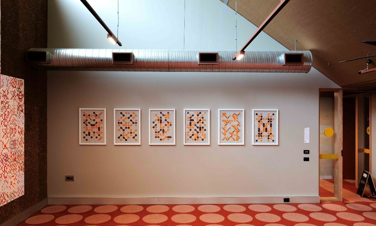 Six frames are lined up on a wall depicting the screen prints made by participants.
