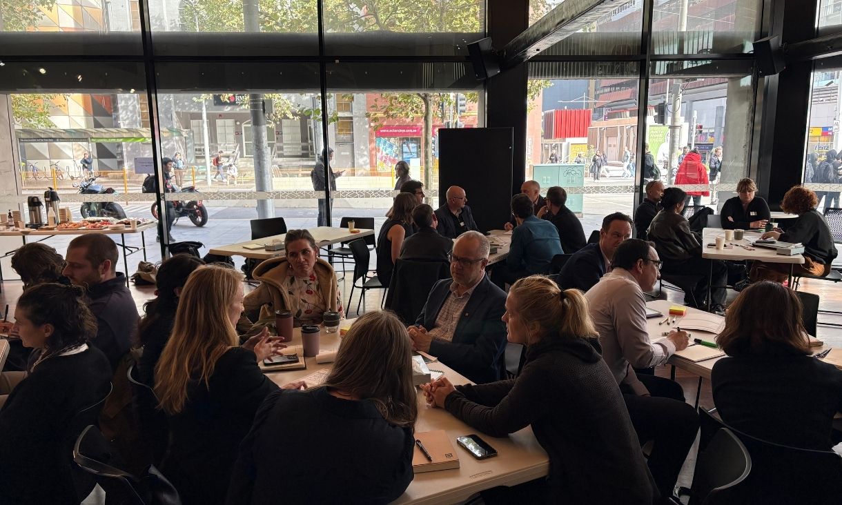 people sit at crowded tables, in discussion