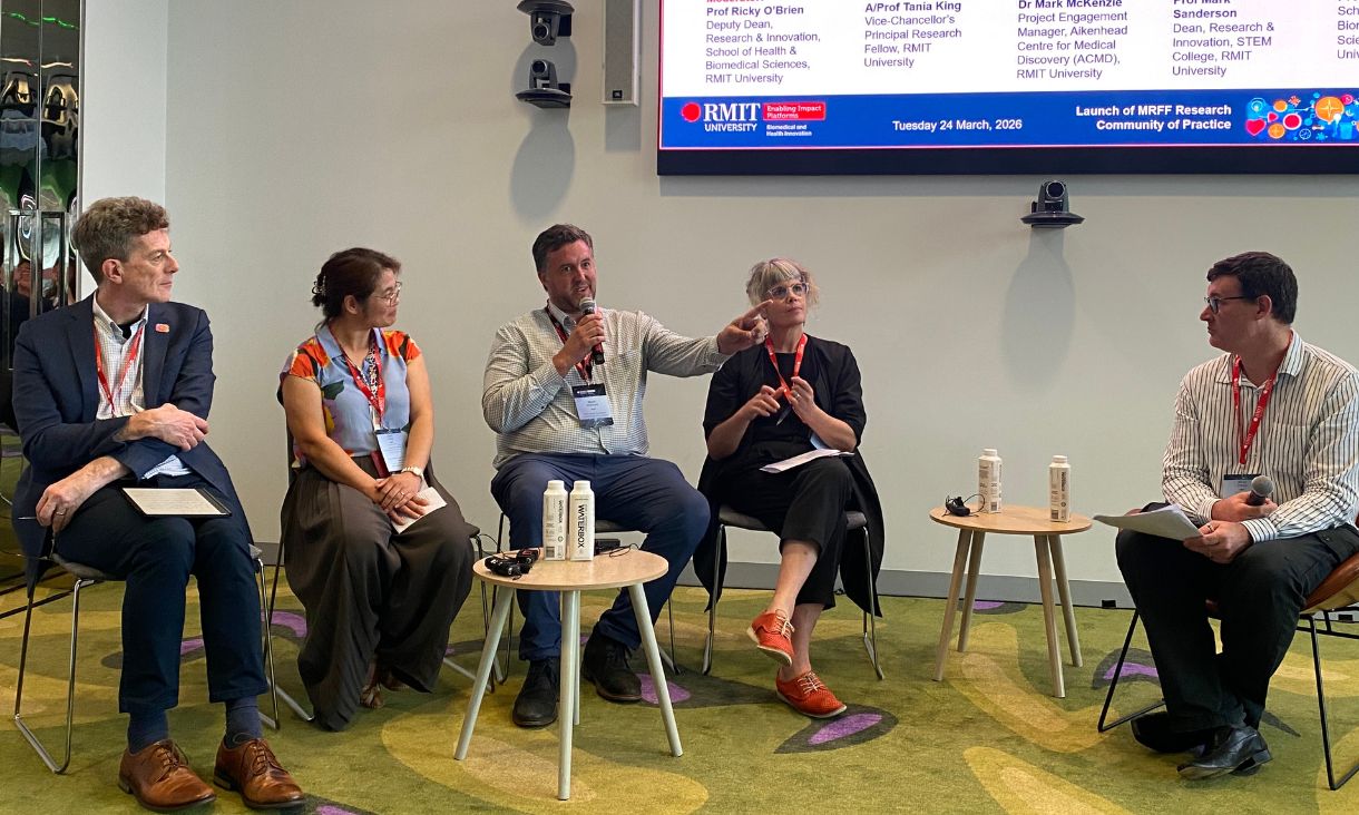Five people engaged in panel discussion