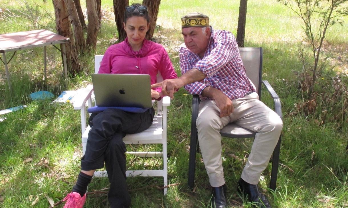 Christine sits on an outdoor lawn chair with Uncle Leonard Clarke. 