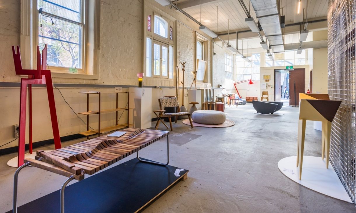 A gallery space is filled with items of furniture 