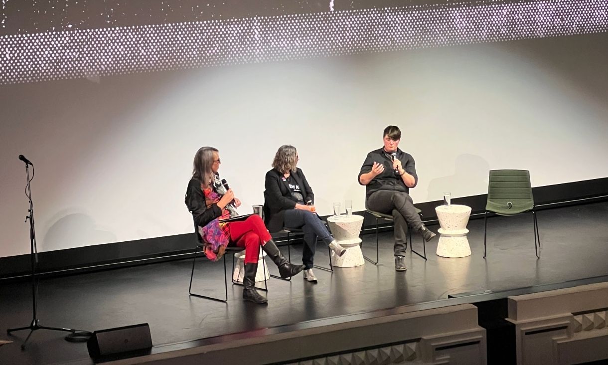 three people sit on a panel in discussion at the capitol