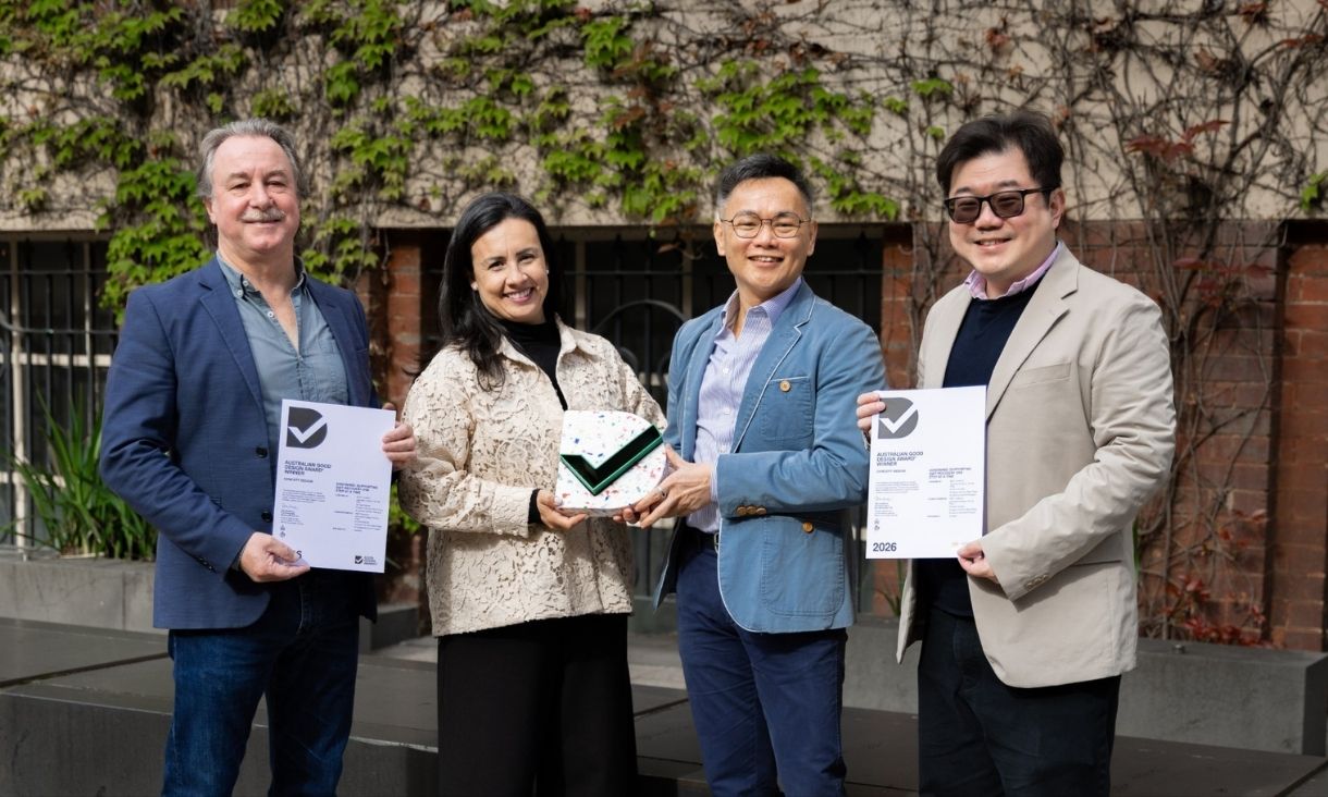 the award winners stand with their certificates and Good Design Award