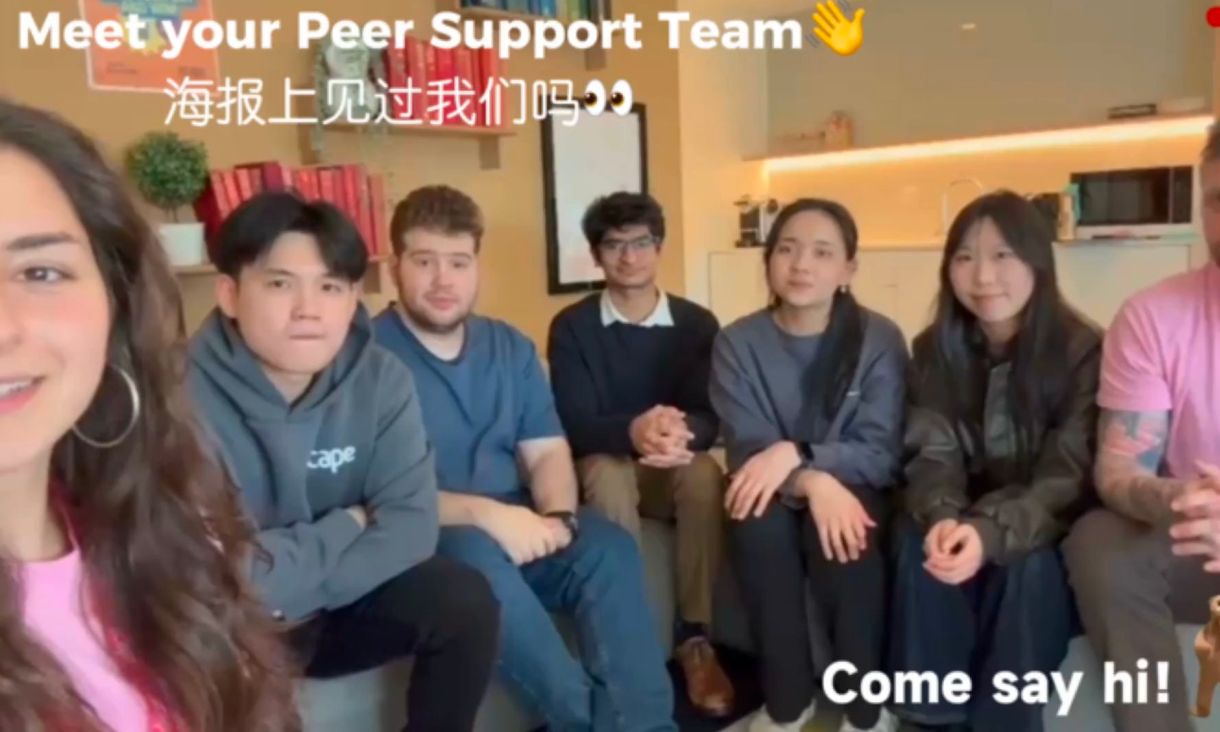 a group of students sit together with the text "meet your peer support team" "come say hi!"