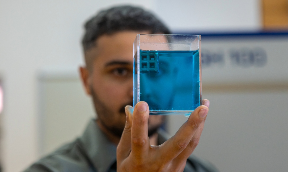 Dr Jordan Noronha holding a sample of the floating titanium. Credit: Sara Tan, RMIT.