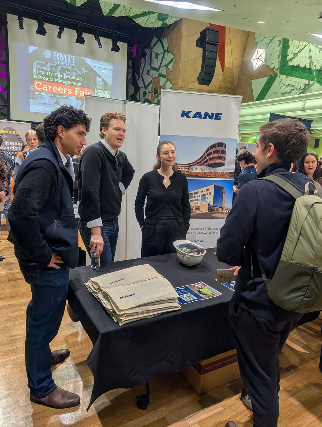 A student talking to representatives from building group KANE at the PCPM careers fair