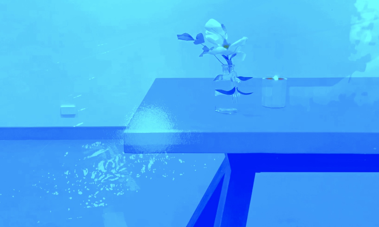 frame from 'sit still' showing table and vase in blue wash