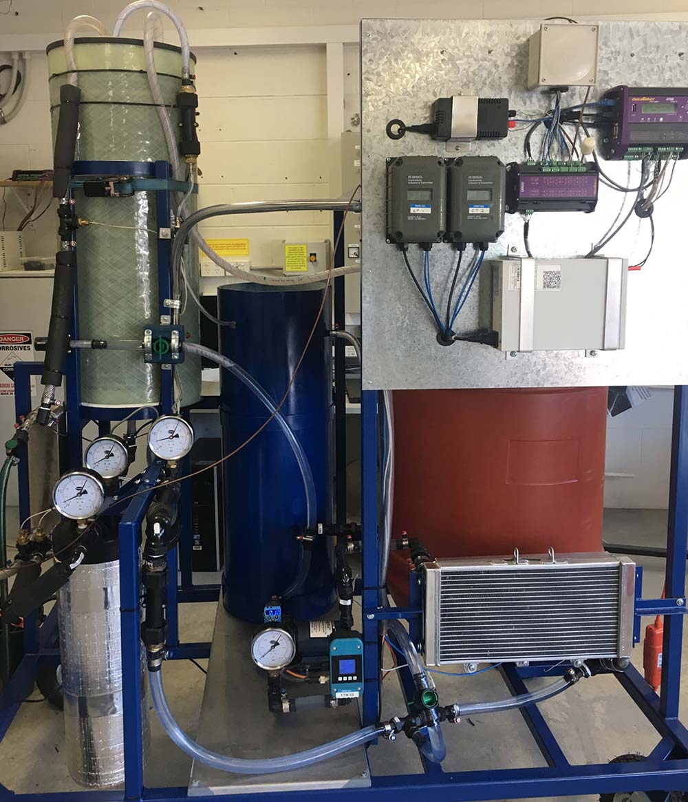 The image shows the experimental setup of a direct contact membrane distillation (DCMD) system used for desalination research. The system features a 10 m² membrane module capable of producing approximately 1 m³ of fresh water per day.