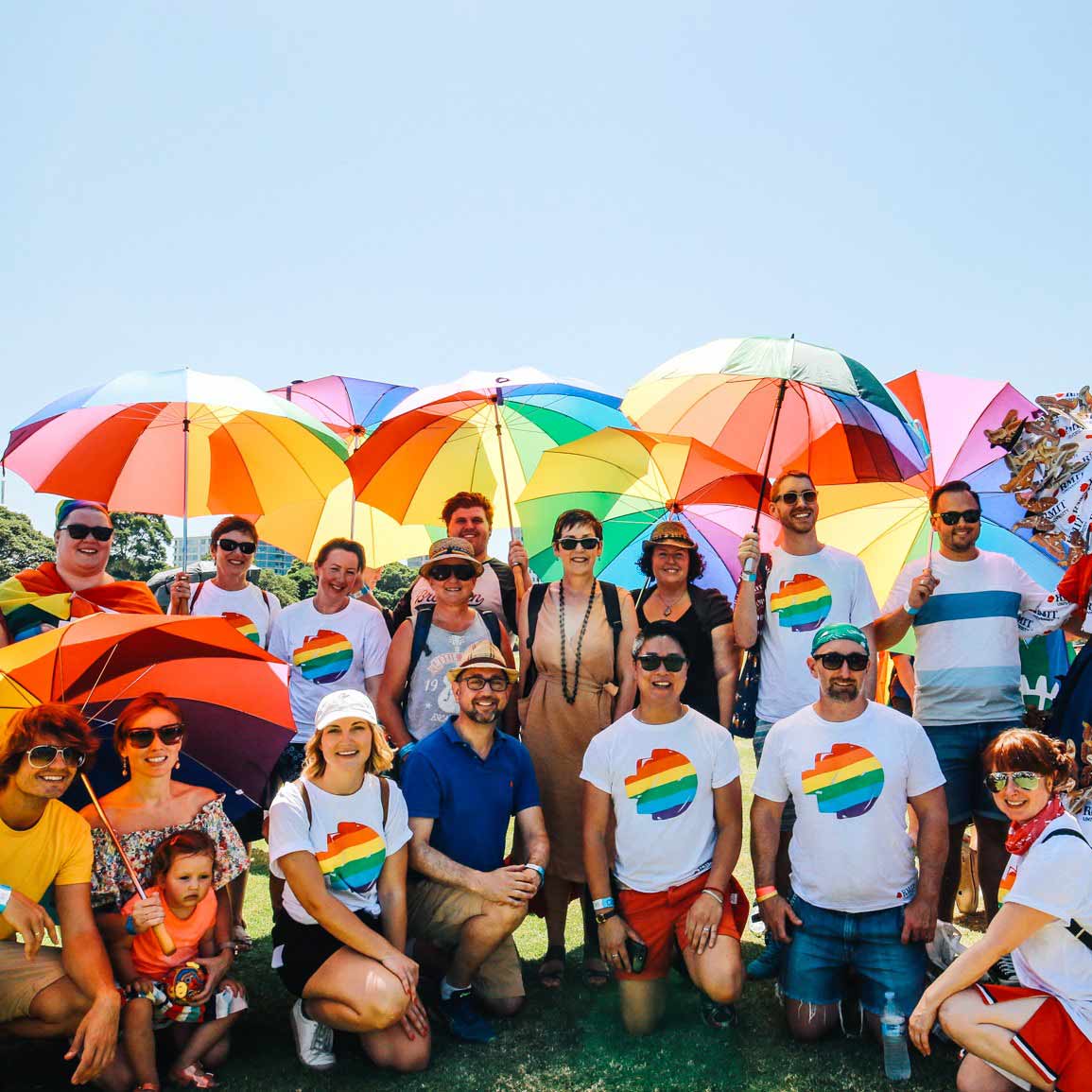 Group of people with rainbow umbrellas
