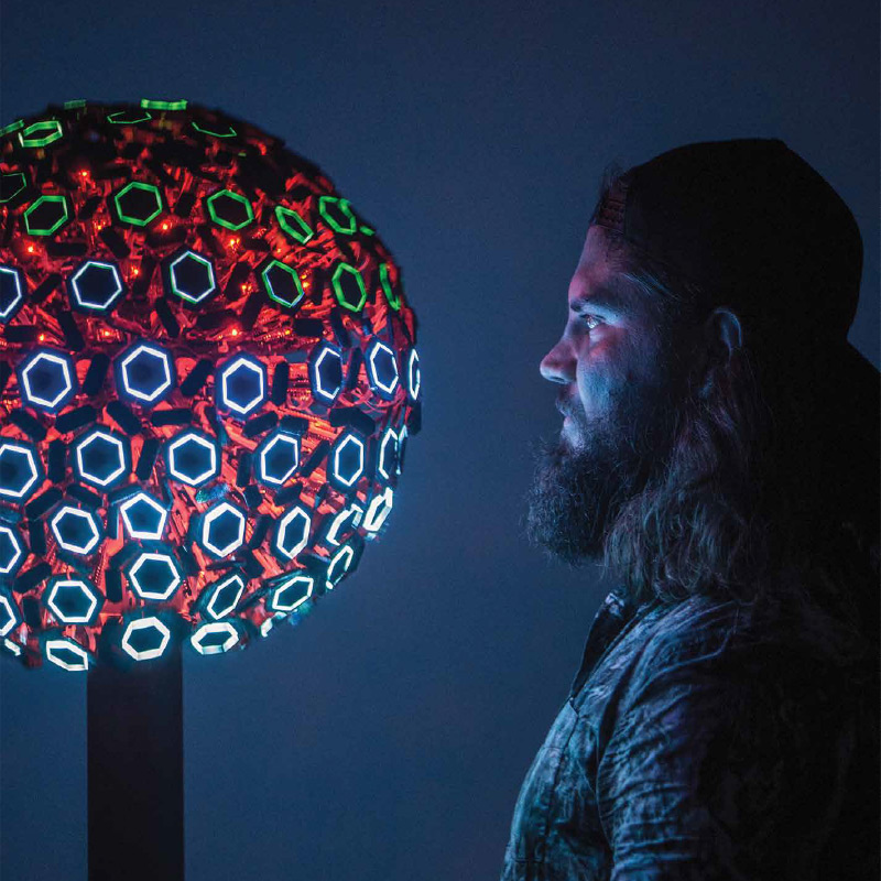 Future of tangible articulated interfaces by Nick Perello Design Institute of Australia – Graduate of Year Victoria 2017. Image of a person looking at a glowing object