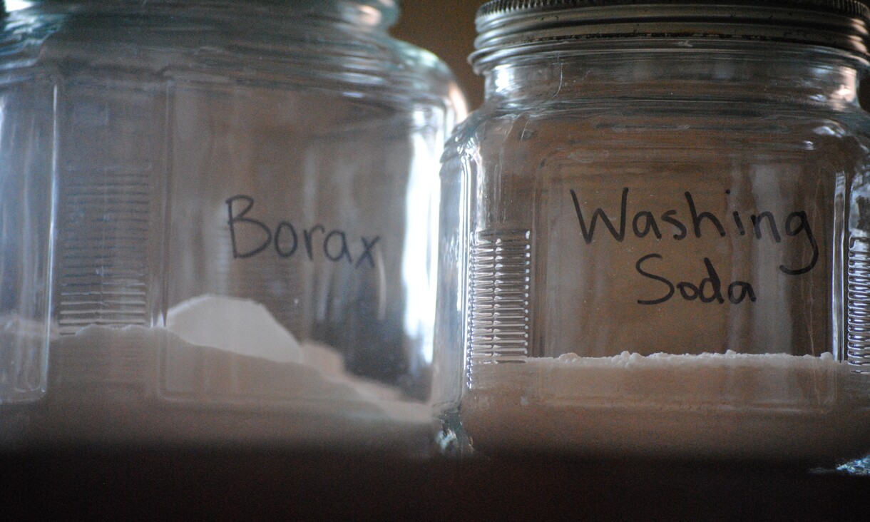 two jars containing white powder, one labelled Borax, the other labelled washing soda