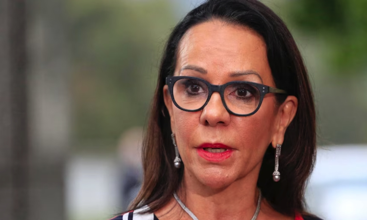 headshot of Indigenous Australians Minister Linda Burney  wearing black-rimmed glasses.