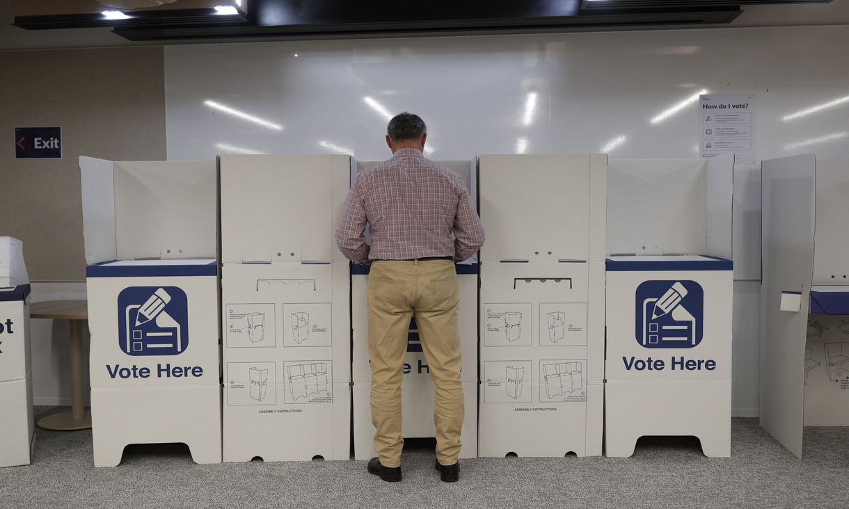 man voting at ballot box