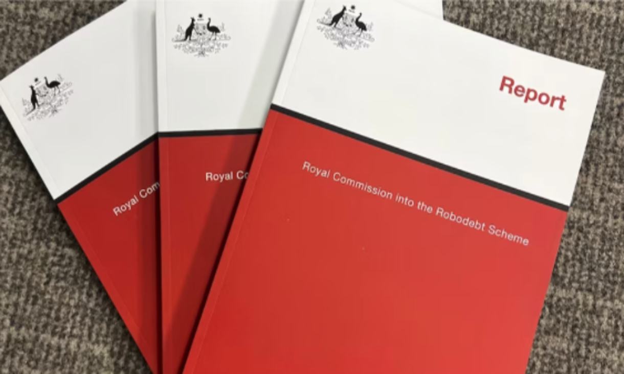 Three red and white reports titled Royal Commission into the Robodebt Scheme.