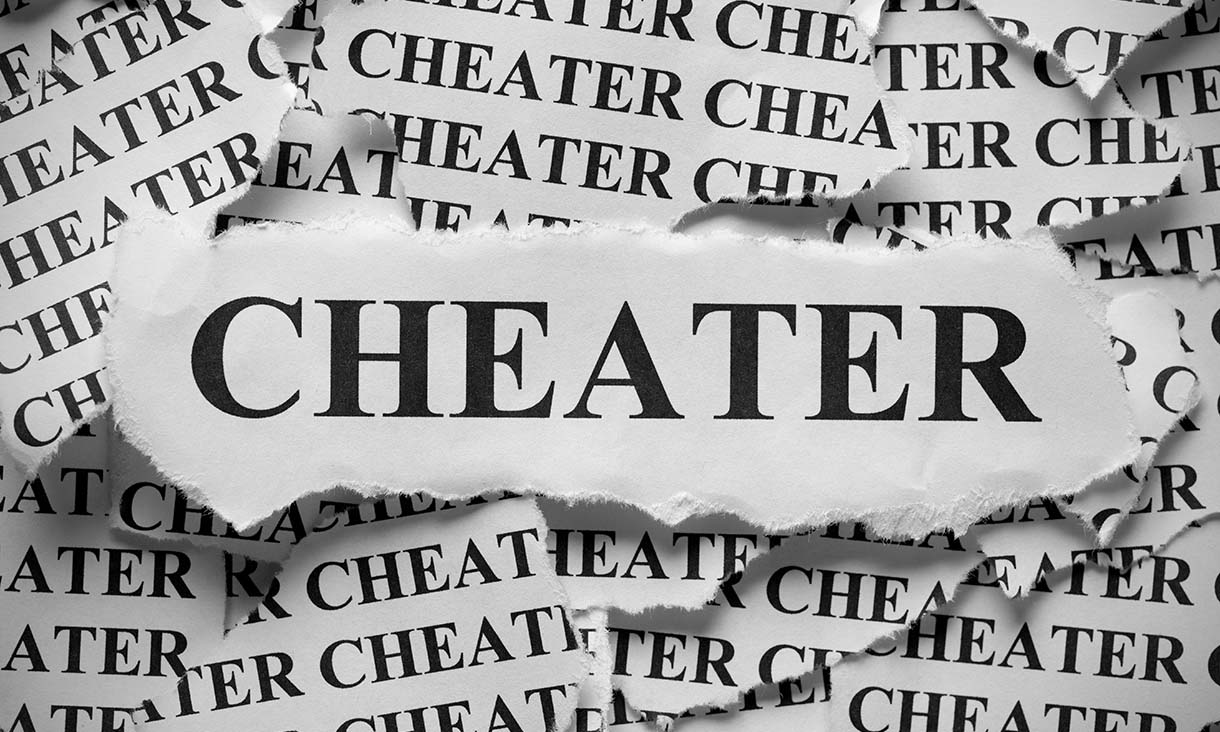 The word "cheater", written on paper that looks as if it has been ripped from a newspaper