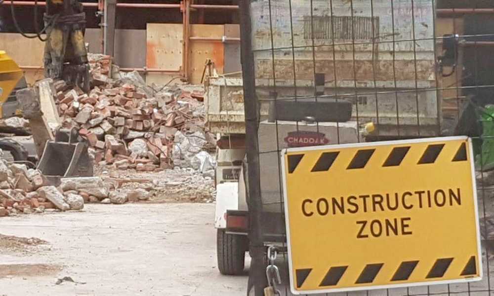 Construction zone sign with truck and rubble