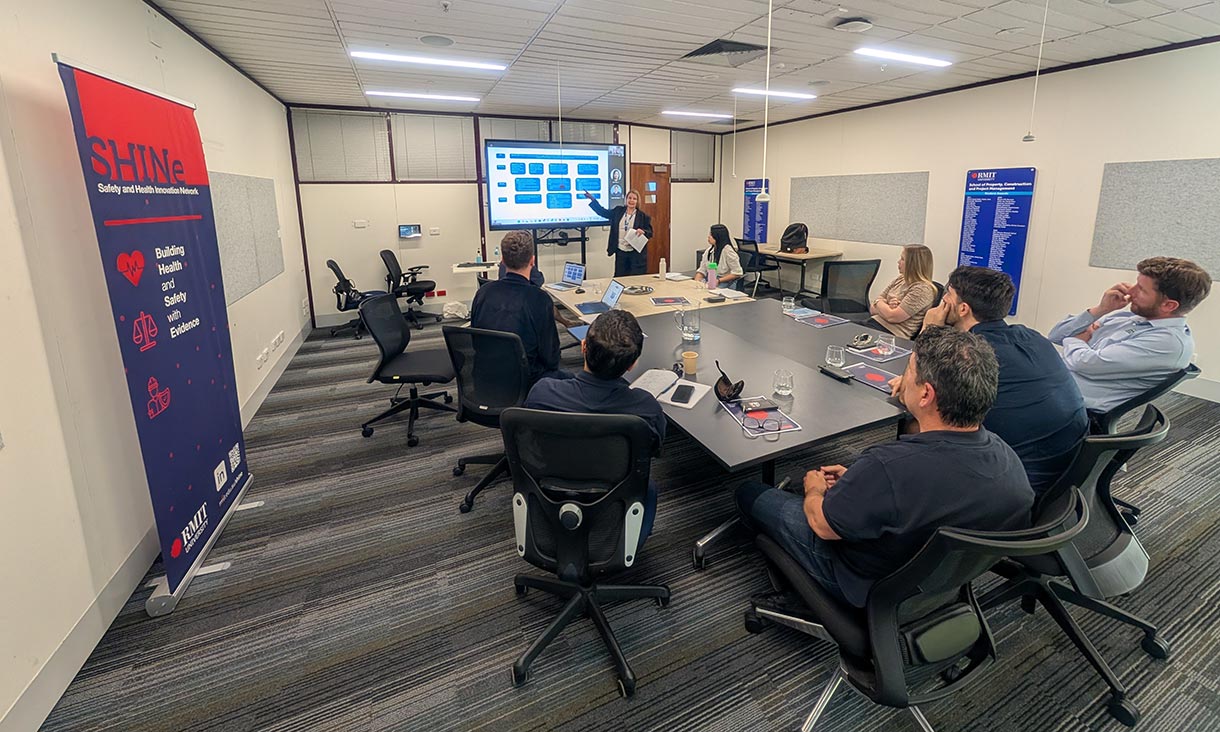 Staff in a meeting room listening to a presentation