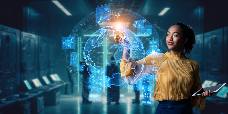 Young black woman in computer lab working with 3D projection of globe.
