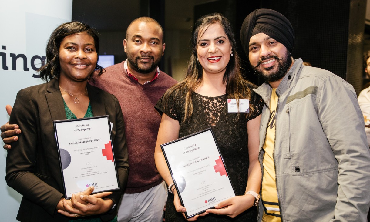 Group of four SHBS students holding their awards