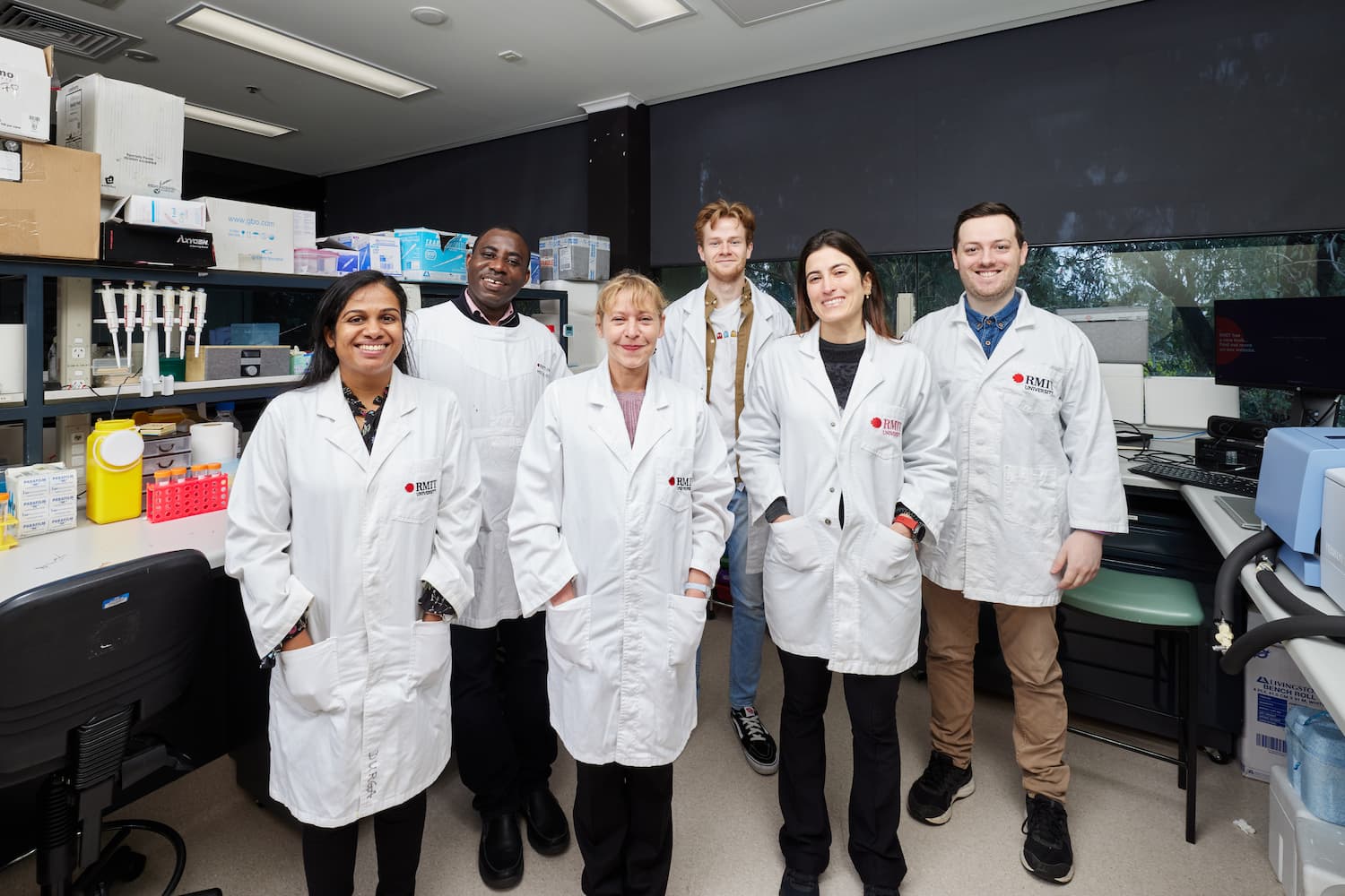 Group of six researchers in RMIT lab coats