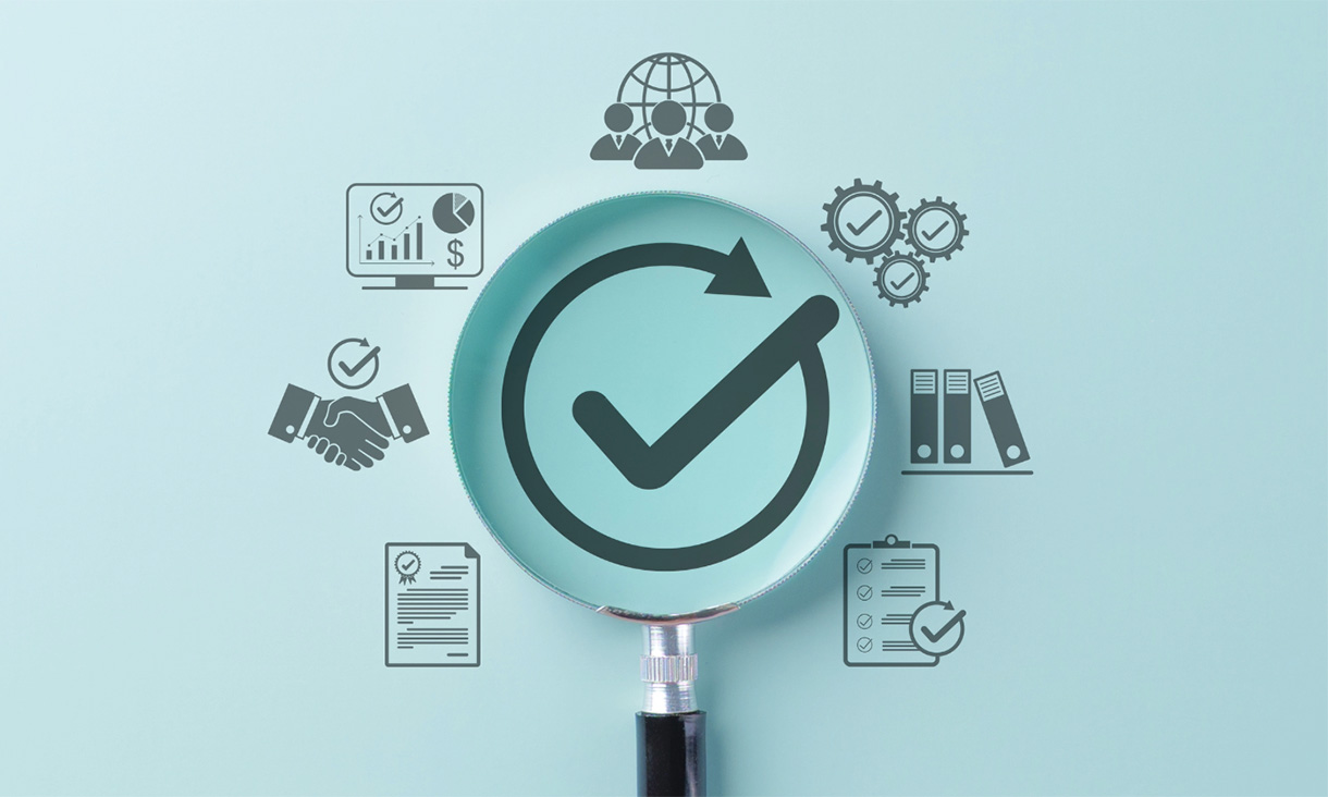 Magnifying glass over a tick symbol, surrounded by icons representing business, data, teamwork and organisational processes.