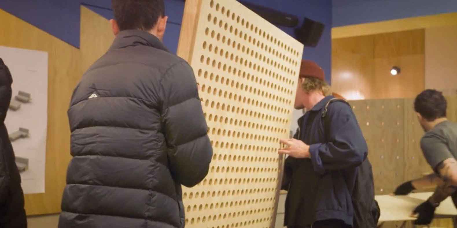 Students carrying wall frame for tiny house