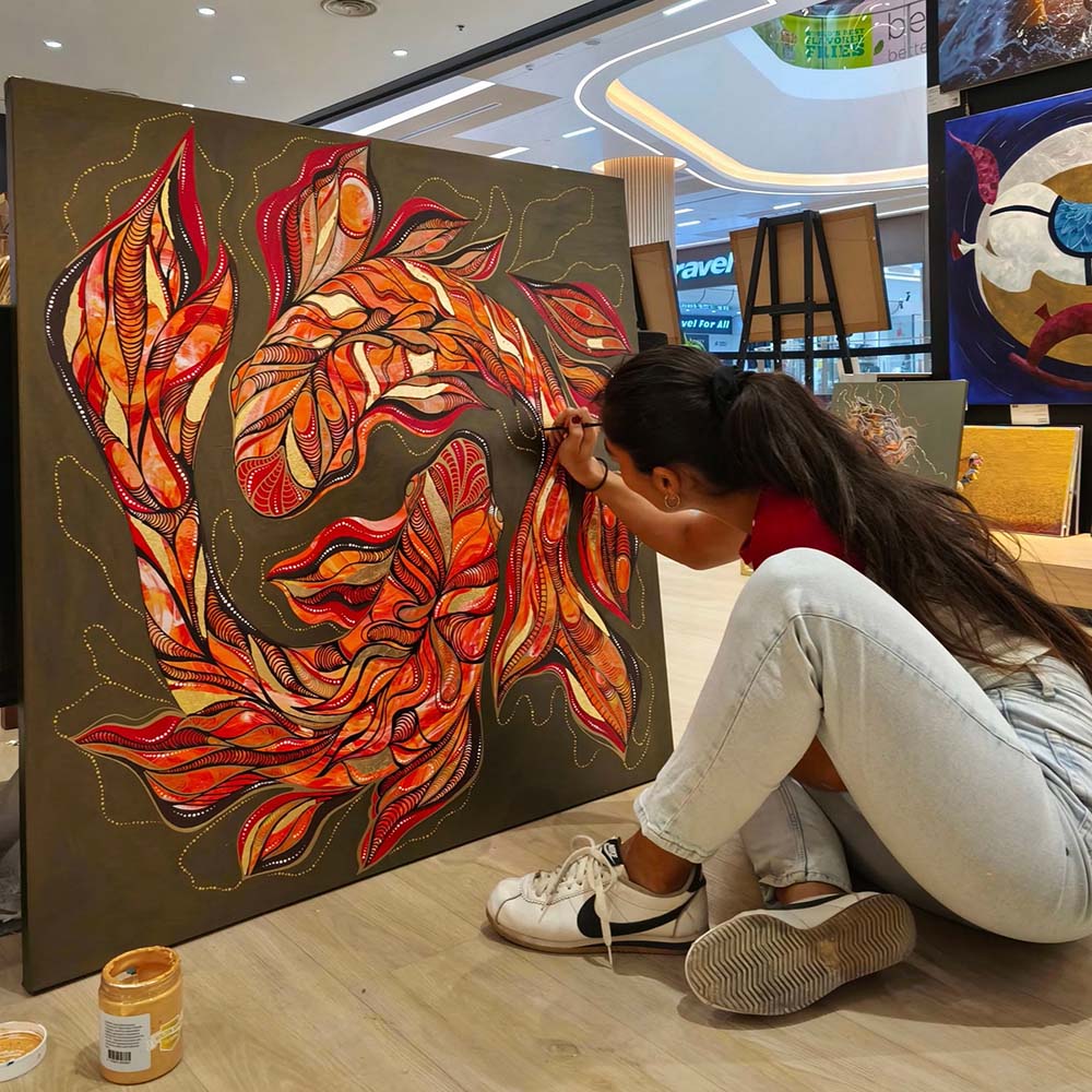 Image of Anya working on her artwork.