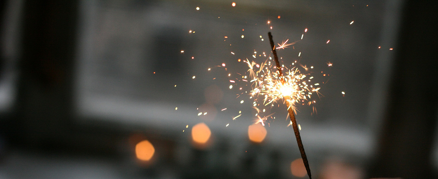 A sparkler lit up at night.
