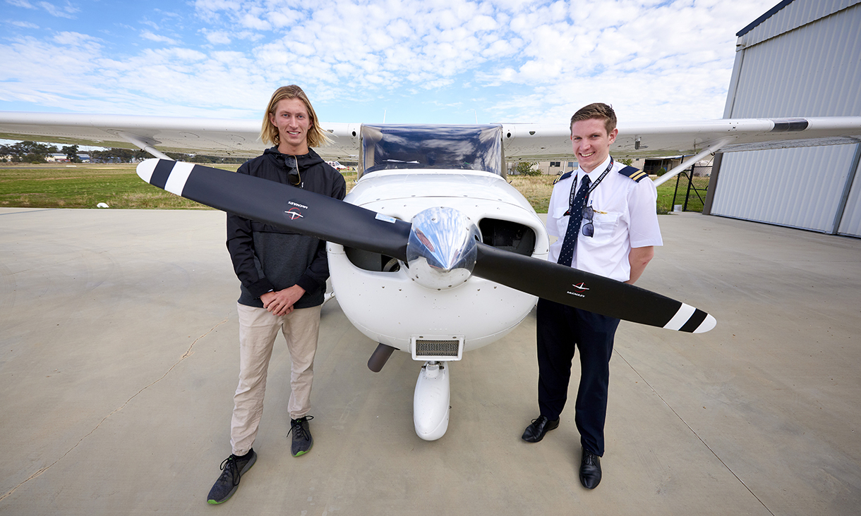 Bendigo flight training, pilot and student standing in front of a single propeller plane