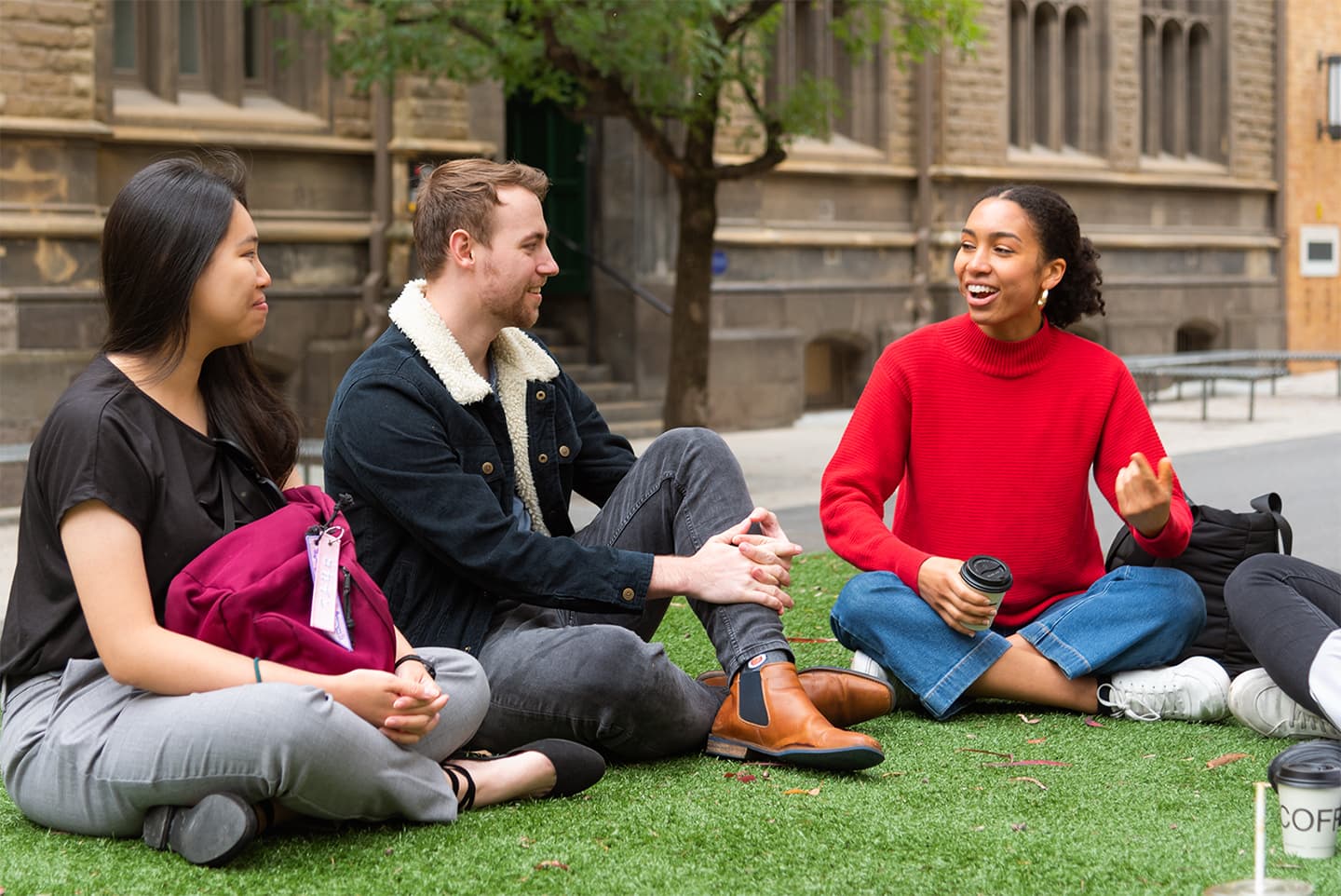 RMIT students on city campus sitting and chatting in front of Building 1